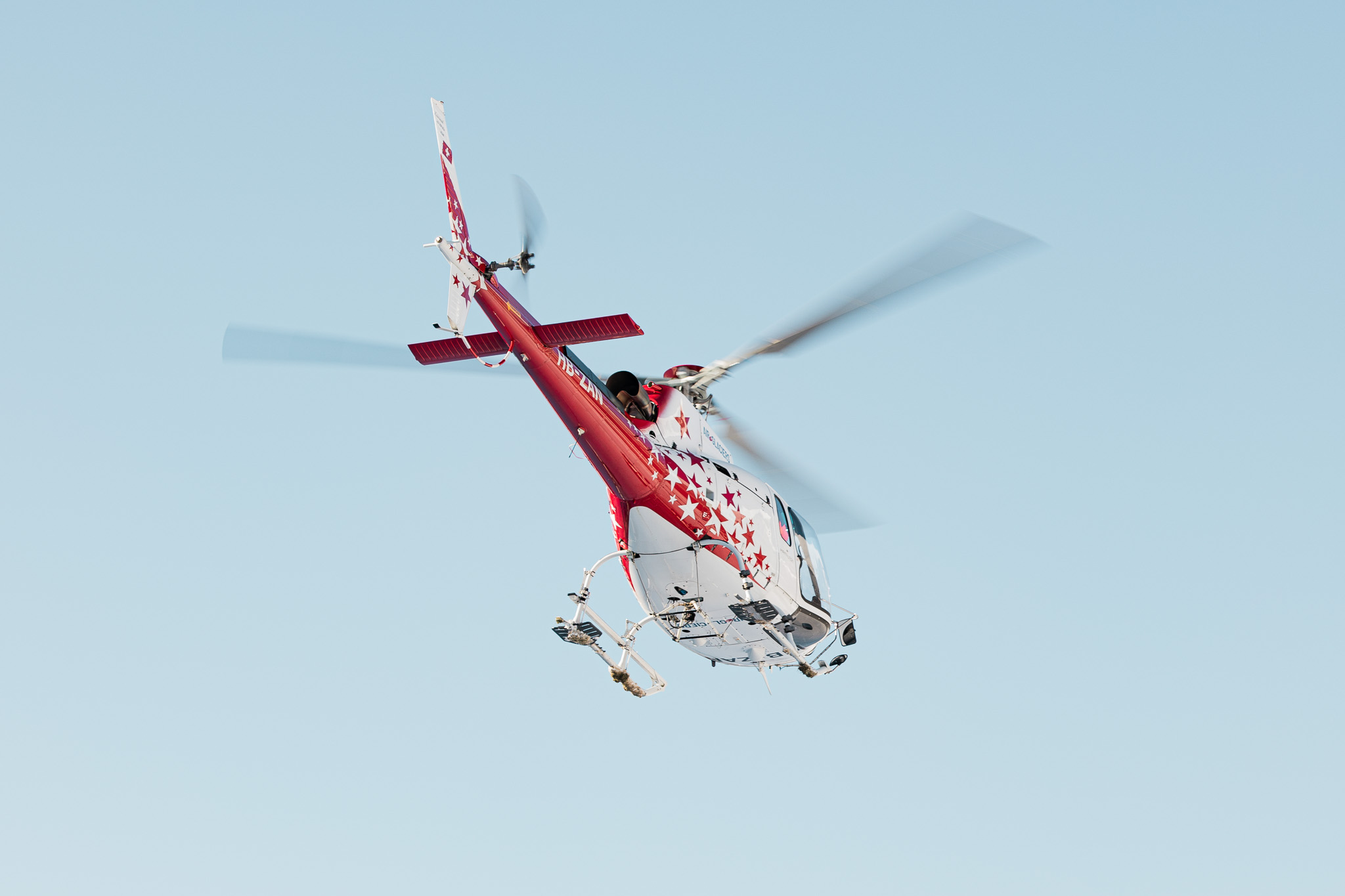 Helicopter, type H125 / AS350 in front of a blue sky